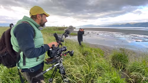 Phil Stebbing filming Ruud Kleinpaste beside Wairarapa Moana
